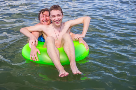 A woman is playing in a sea with her son