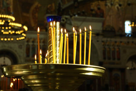 Candlestick with burning candles in the temple. Russian Orthodox Church
