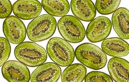 sliced kiwi on a white background lit from belowの写真素材