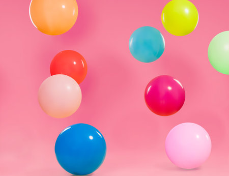 Colorful different balloons with pink background