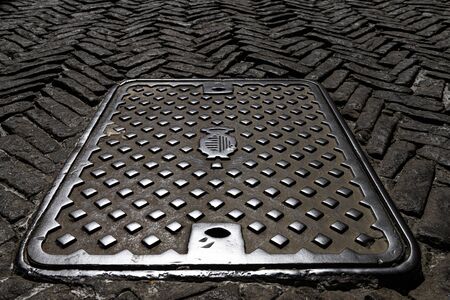 Old shaft cover on the paving streetの写真素材