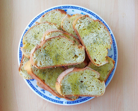 Bread slices served in a plate with olive oil and origan condimentの写真素材