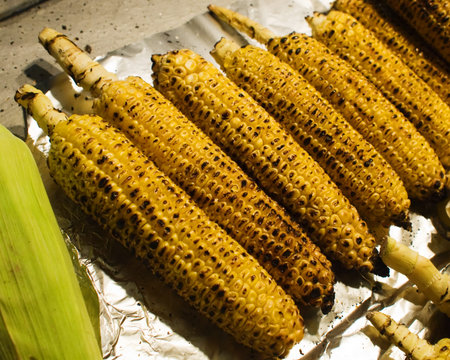 Row of grilled corn cobs