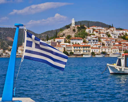 Greek flag and a island view as an out of focus backgroundの写真素材