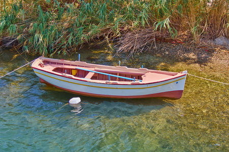 small wooden fishing boat in quiet beach
