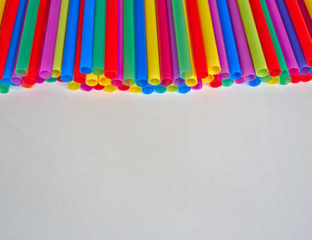 variety of drinking straws on white paper, space for typingの写真素材