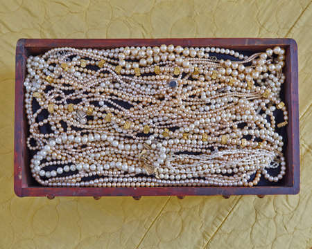 pearls in vintage wooden crib, precious backgroundの写真素材