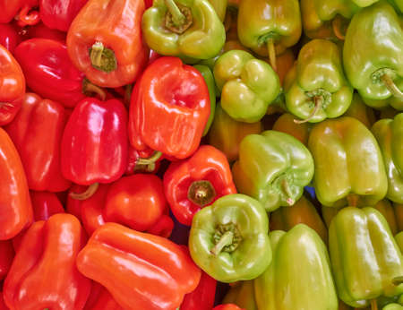 red and green natural background made of bell peppersの写真素材