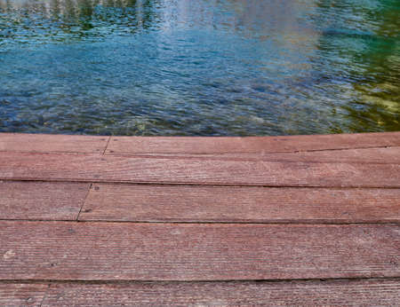 wooden planking beside a lake spa and resortの写真素材