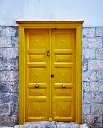 vintage house yellow door in a Greek island villageの写真素材