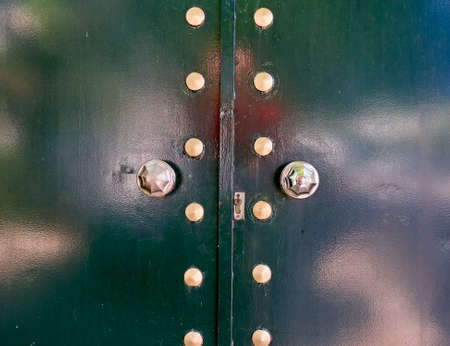 metalic green door detail with bronze knob and decorationの写真素材
