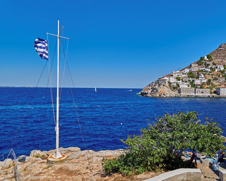 Greek flag and Hydra island town viewの写真素材