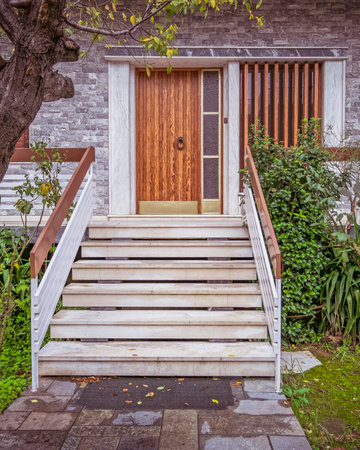 marble stairs to family house entrance natural wood door with transom windowの写真素材