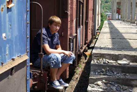 Boy in abandoned train stationの写真素材