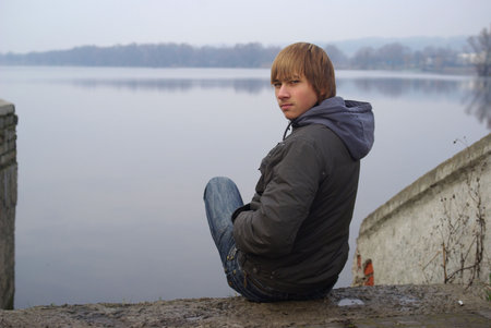 Young boy lakesideの写真素材