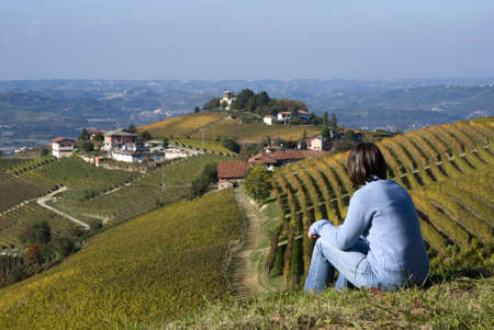 Woman sitting on a hill looking a the view の写真素材