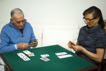 Elderly couple playing a game of cardsの写真素材