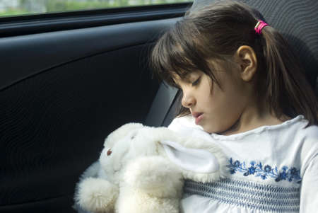Girl sleeping in the carの写真素材