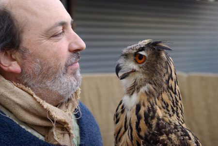 Taggia, Italy  February 27, 2010: Patrizio  Merelli - Falconer of the Italian Federation Historical Games (FIGS) in a performance demonstration of the training of the European eagle owlのeditorial素材