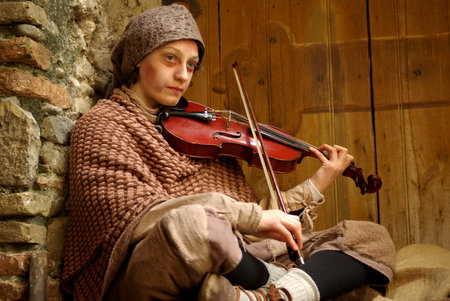 Taggia, Italy – February 28, 2010: Participant of medieval costume party. This image:  Young...
