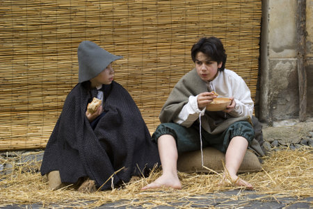 Taggia, Italy  February 27, 2011: Historical reenactment participants. This image: Poor children in the streetのeditorial素材