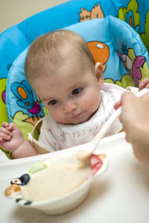 Mother feeding caucasian babyの写真素材