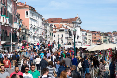 Venice, May 4, 2014  Tourists walking along the famous Venice pedestrian promenade in front of Saint Mark Square - is the principal public square of Venice のeditorial素材