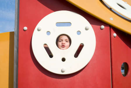 Happy little girl on the playgroundの写真素材