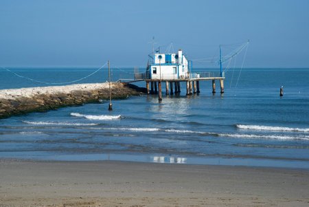 Adriatic, Italy. Stilt house by the sea and fishing nets