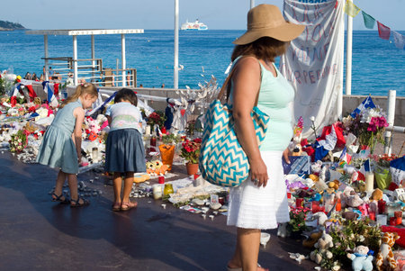 Nice, France - August 2, 2016: People bring flowers and dolls to remember the victims of the terrorist attack of the 14th July 2016 Niceのeditorial素材