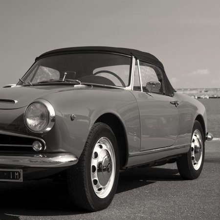 Imperia, Italy - July 29, 2016: Alfa Romeo Giulietta Spider cruising on the road in Imperia During...