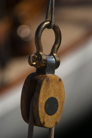 Image of closeup of pulley and rope on old sailing shipの写真素材