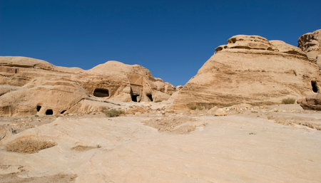 Rock cut tombs at the entrance to ancient Nabatean city of Petra, Jordan