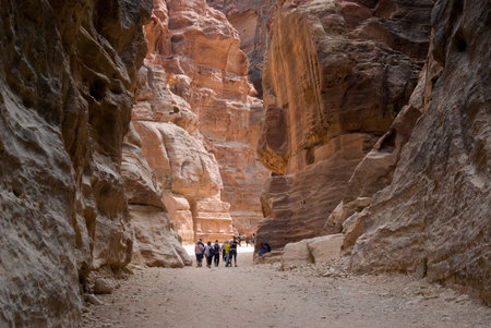 Petra, Jordan - October 26, 2016: Tourists walking through the Siq, past ancient wall carvings, towards the entrance to Petra, Jordanのeditorial素材