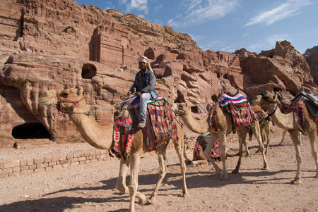 Petra, Jordan - October 26, 2016: Bedouin man with camels in the ancient Nabatean city of Petra, Jordanのeditorial素材