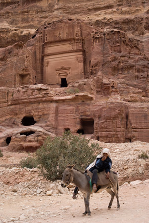 Petra, Jordan - October 26, 2016: Beduin man riding donkey in the ancient Nabatean city of Petra, Jordanのeditorial素材