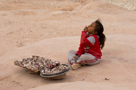 Petra, Jordan - October 26, 2016: Jordanian Bedouin girl sells souvenirs in Petraのeditorial素材