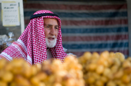 Amman, Jordan - October 24, 2016: Jordanian senior man selling fruits in the downtown market of...