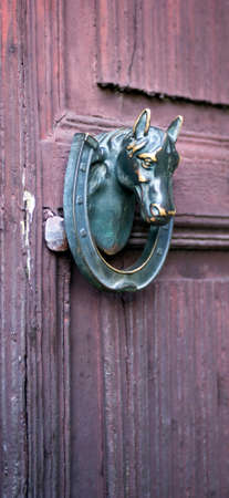 Door knocker in form the horse head and horseshoeの写真素材