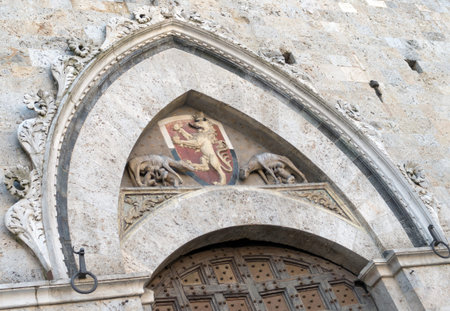 Architectural detail above the front entrance to Siena Town hall, Italyの写真素材