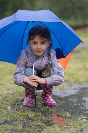 Girl with an umbrella in the rainの写真素材