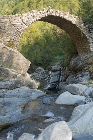 Ruins of arch bridge in mountains, Rezzo municipality, Province of Imperia, Italyの写真素材