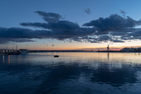 Dramatic clouds at sunset over the harbour, Imperia, Liguria region, Italyの写真素材