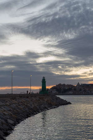 Signal light of breakwater at the mouth of a harborの写真素材