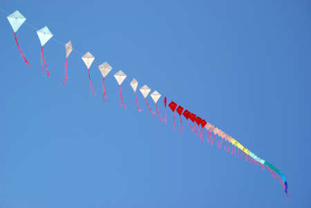 Low angle view of kite flying against clear skyの写真素材