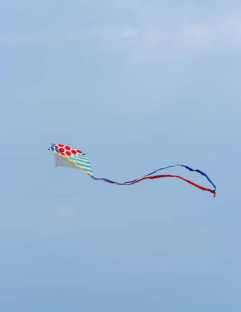 Low angle view of kite flying against clear skyの写真素材