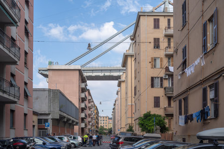 Genoa, Italy - October 9, 2018: Apartment buildings are seen under the Morandi motorway bridge in Genoa, collapsed, on August 14, sending vehicles and tons of rubble to the ground and killing 43 people.のeditorial素材