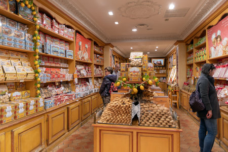 Menton, France - February 25, 2019: An old confectionery shop in the Menton old town. Some customers are looking to choose what to buyのeditorial素材