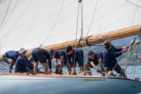 Imperia, Italy - September 7, 2019: Crew members aboard on sailboat Tuiga, flagship of the Monaco Yacht Club, during racing in Gulf of Imperia. Established in 1986, the Imperia Vintage Yacht Challenge Stage is a of the most important event in sailing the のeditorial素材