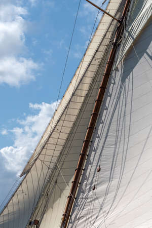 Sail of a sailing boat against skyの写真素材